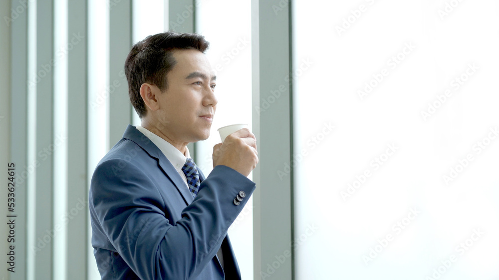 Senior manager drinking a coffee during a coffee break in afternoon. Senior manager drinking a coffee during a coffee break in afternoon.