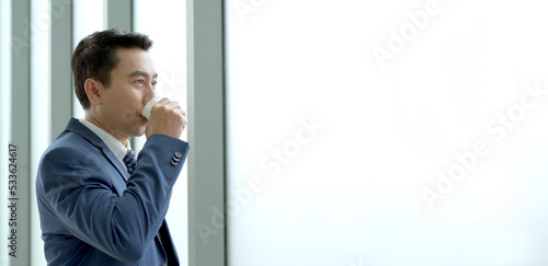 Senior manager drinking a coffee during a coffee break in afternoon.