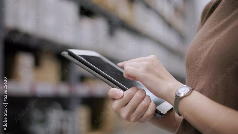 Close-up hand manager worker checklist manage parcel box product with tablet in warehouse. Supervisor using tablet working at store industry. Logistic import export concept. Business owner inspection. Close-up hand manager worker checklist manage parcel box product with tablet in warehouse. Supervisor using tablet working at store industry. Logistic import export concept. Business owner inspection.