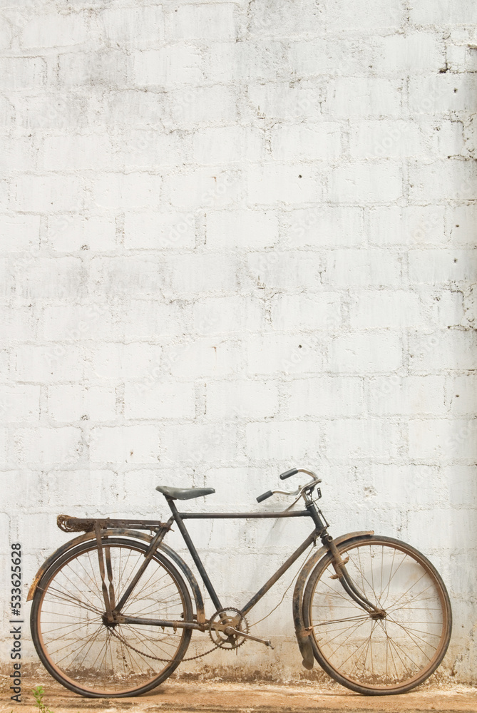 old bicycle parked, lean on old brick concrete grunge wall and window. vintage color, hipster style, urban lifestyle sri lanka. old bicycle parked, lean on old brick concrete grunge wall and window. vintage color, hipster style, urban lifestyle sri lanka.