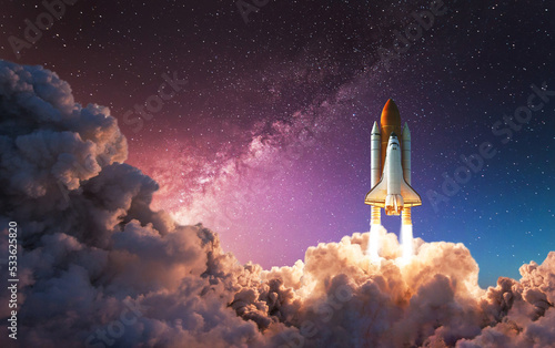 Fototapeta Naklejka Na Ścianę i Meble -  Space shuttle takes off into the night sky on a mission. Rocket launch into space Artemis manned space program concept