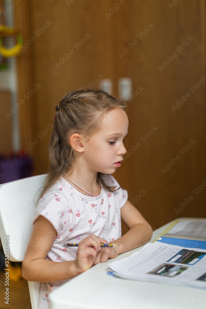 Girl doing her homework from at her desk Girl doing her homework from at her desk