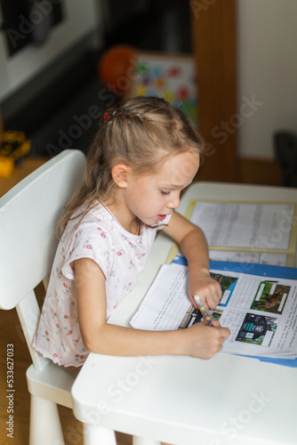 Girl doing her homework from at her desk