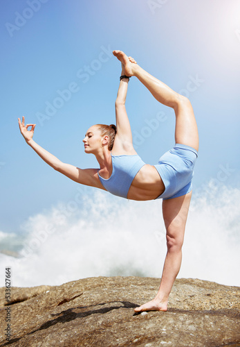 Beach meditation, yoga stretching and woman doing zen fitness training in nature, balance for spiritual health and wellness for body on the rocks. Athlete with flexibility during workout at the sea