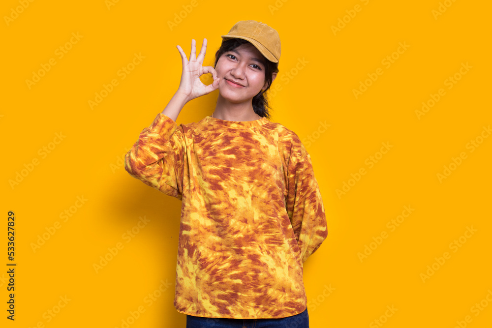young asian beautiful woman with ok sign gesture tumb up isolated on yellow background
young asian beautiful woman with ok sign gesture tumb up isolated on yellow background