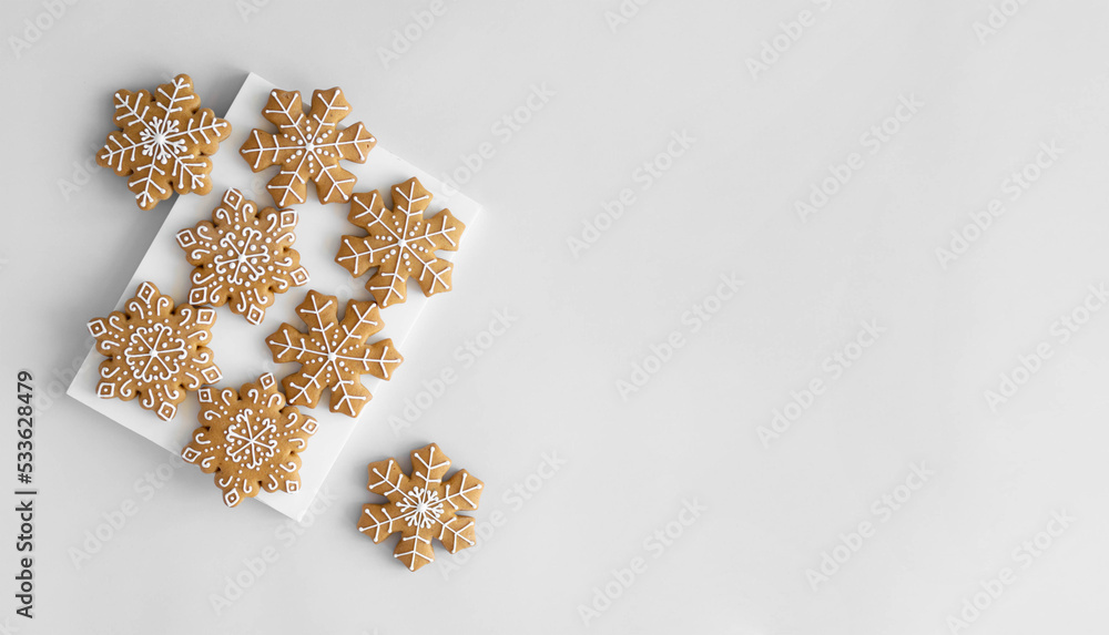 New Year's traditional gingerbread cookies decorated with sugar icing on a light background New Year's traditional gingerbread cookies decorated with sugar icing on a light background