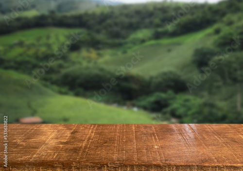 Fototapeta Naklejka Na Ścianę i Meble -  Wooden table top on blur rice field mountain and grass field.Fresh and Relax concept.For montage product display or design key visual layout.View of copy space.