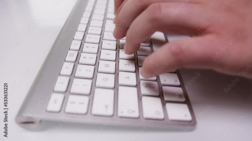 Close-up of Fingers Typing Something on White Keyboard Close-up of Fingers Typing Something on White Keyboard