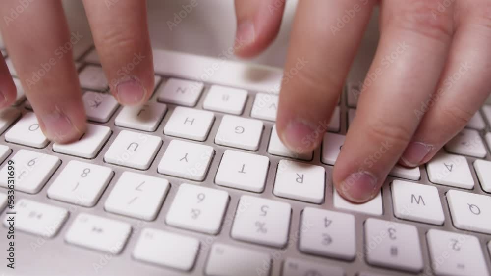 Close-up of Fingers Typing Something on White Keyboard Close-up of Fingers Typing Something on White Keyboard