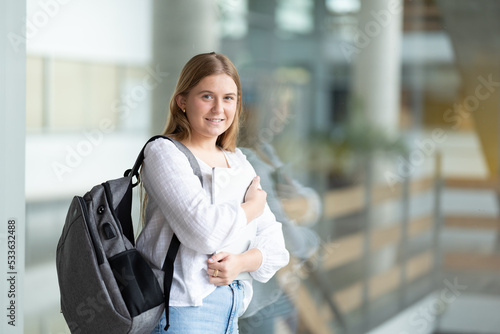 Canvastavla Portrait of smiling chubby university student girl holding laptop in college