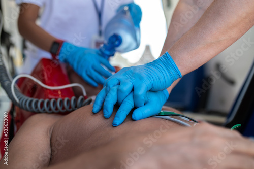 Paramedical staff performing the heart massage and oxygenation procedure