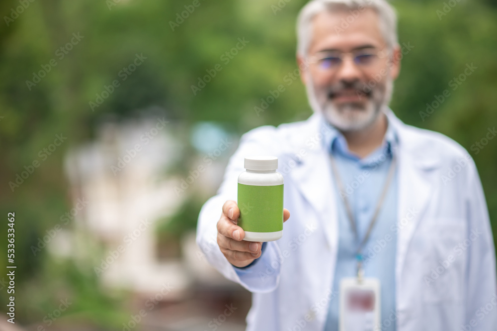 Smiling man in a lab coat with a cup of coffee Smiling man in a lab coat with a cup of coffee