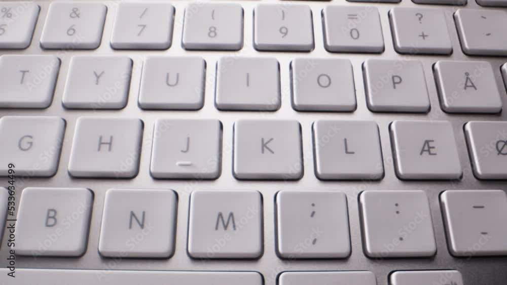 Close-up of Buttons of Wireless White and Silver Keyboard Close-up of Buttons of Wireless White and Silver Keyboard