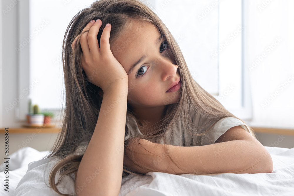 Portrait of a charming little girl in bed early in the morning. Portrait of a charming little girl in bed early in the morning.