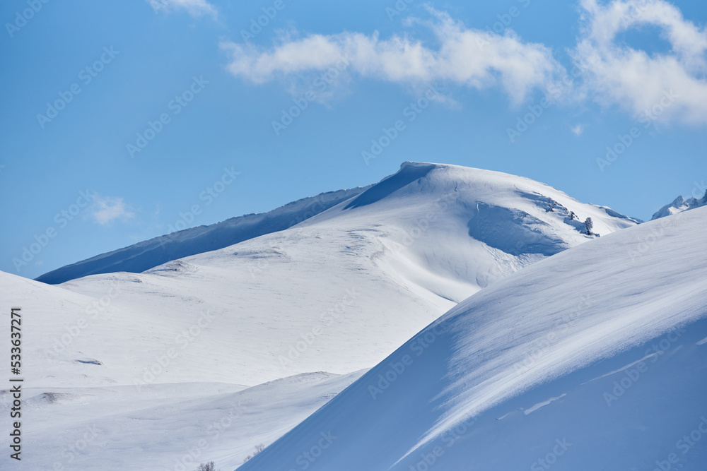 Very snowy mountains in a sunny day