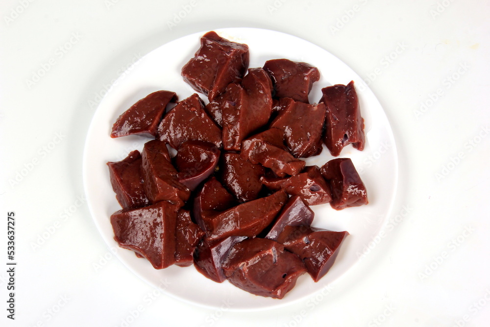 Sliced raw liver on a white plate Sliced raw liver on a white plate