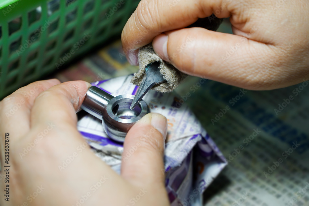 Fototapeta premium Asian workers chamfering the workpiece,production process concept