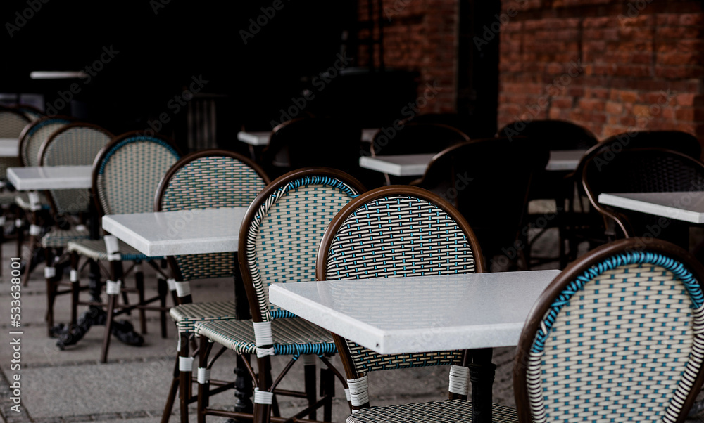 Empty tables in street cafe.