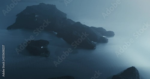 Fairy island on blue moonlight night backdrop aerial view. Ocean water bright moon glow reflection. Exotic mountain silhouette. Cinematic mystery Halloween scene. Philippines tropical vacation travel. photo