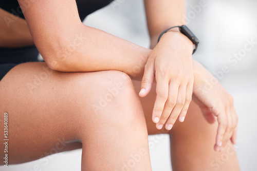 Hands of sports woman sitting on break from fitness training for health  wellness and cardio workout. Healthy girl marathon or triathlon runner athlete tired or fatigue from exercise rest and relax