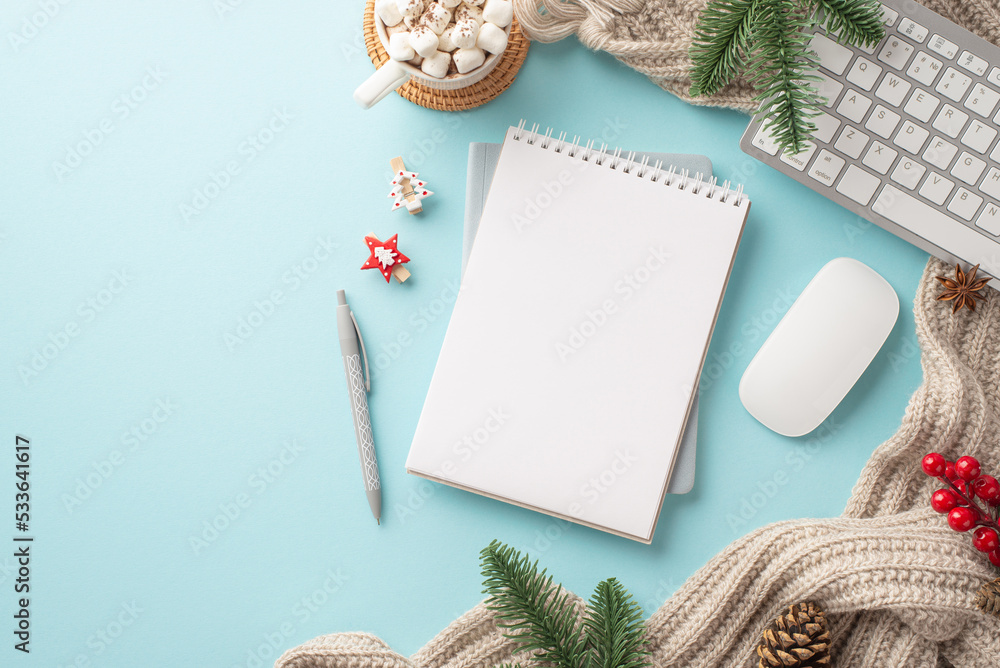 Top view photo of keyboard computer mouse notepad pen cup of hot drinking with marshmallow knitted blanket spruce branches pine cone mistletoe clips on isolated light blue background with empty space Top view photo of keyboard computer mouse notepad pen cup of hot drinking with marshmallow knitted blanket spruce branches pine cone mistletoe clips on isolated light blue background with empty space