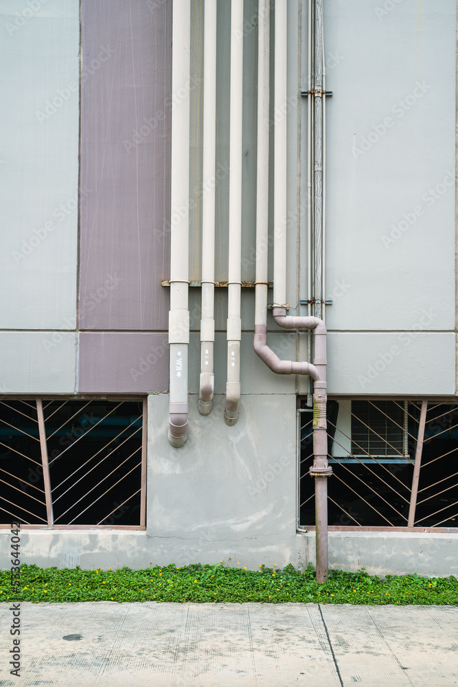 Pipes on a grunge concrete wall.Rows of conduit pipes on a old wall ...