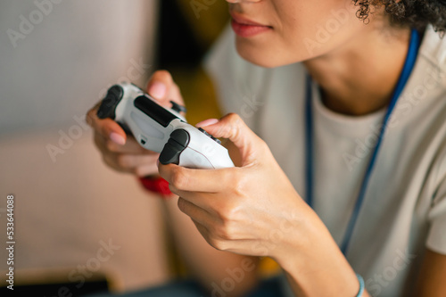 Young girl in white tshirt playong on playstation