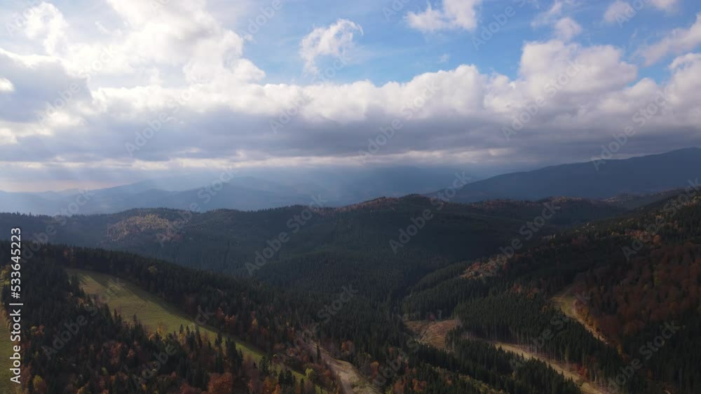 Drone flies over Carpathian mountains in Ukraine, aerial view of scenic landscape with clouds on the sky during autumn Drone flies over Carpathian mountains in Ukraine, aerial view of scenic landscape with clouds on the sky during autumn