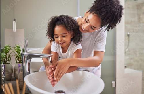 Family, washing hands and child with mom rinsing, cleaning and good hygiene against bacteria or germs for infection or virus protection in bathroom. Girl kid with woman for health and cleanliness