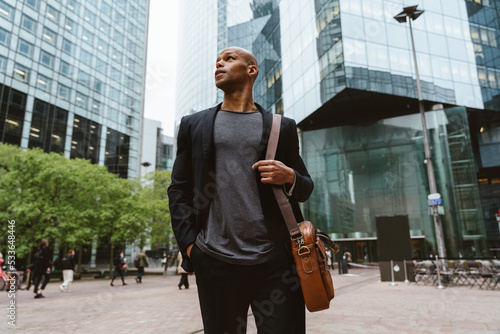 Sticker Young business man going to work in the morning passing by an urban area of the city