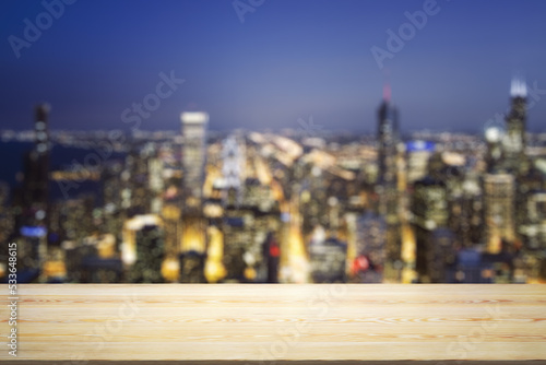 Blank table top made of wooden planks with beautiful blurry cityscape at twilight on background  mockup