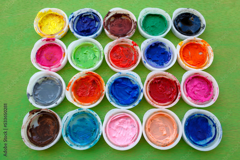 Rows of bright multi colored paint pot lids Rows of bright multi colored paint pot lids