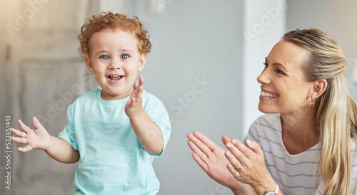 Happy clapping, mother support and kid with energy in living room, smile for celebration and family love in lounge of house. Portrait of baby with joy and applause during child development with mom