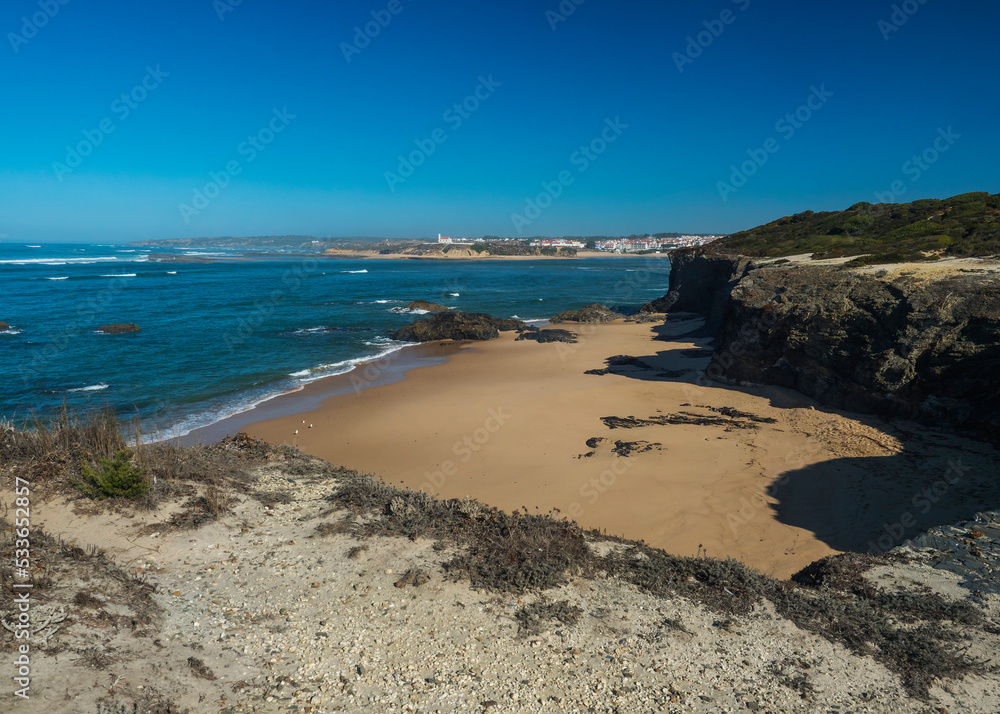 Praia das Furnas sand beach with view over the Mira river to Vila Nova de Milfontes, wild Rota Vicentina Coast Natural Park Portugal. Praia das Furnas sand beach with view over the Mira river to Vila Nova de Milfontes, wild Rota Vicentina Coast Natural Park Portugal.