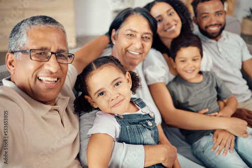 Selfie of children, parents and grandparents in family home, sitting on the sofa in living room. Portrait of happy, smiling and multicultural family taking a picture, bonding and having fun together
