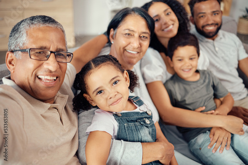 Фотография Selfie of children, parents and grandparents in family home, sitting on the sofa in living room