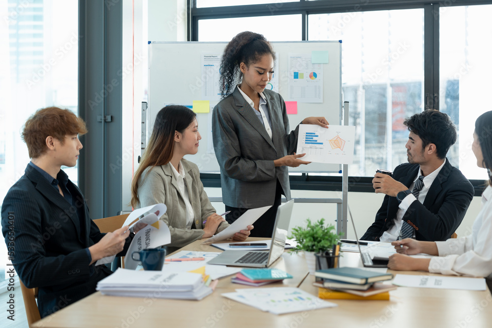 diverse business team people discuss financial result review paperwork share ideas brainstorm collaborate work in teamwork at group briefing table. diverse business team people discuss financial result review paperwork share ideas brainstorm collaborate work in teamwork at group briefing table.