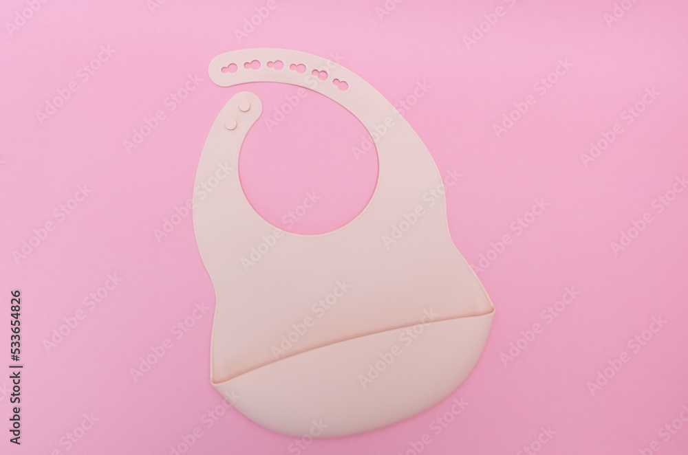 Silicone baby bib. Pastel pink color. top view, flat lay. Silicone baby bib. Pastel pink color. top view, flat lay.