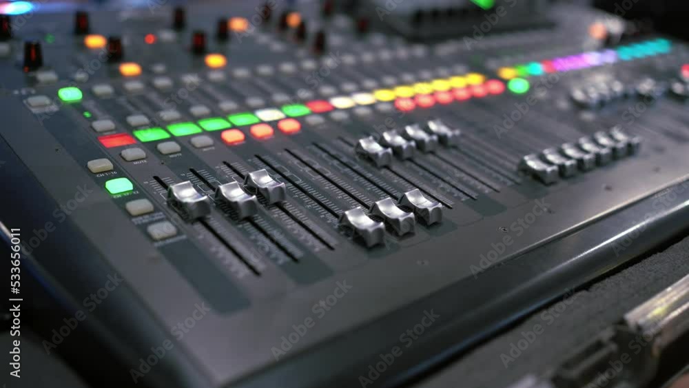 Professional audio mixing console. Mixer. Pro audio mixing board faders and knobs. Static shot of multi-track music recording equipment faders and sliders. Professional audio mixing console. Mixer. Pro audio mixing board faders and knobs. Static shot of multi-track music recording equipment faders and sliders.