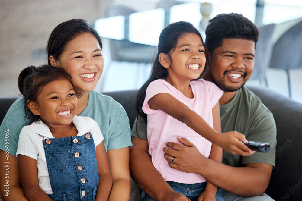 Happy family watching tv and television on sofa in living room