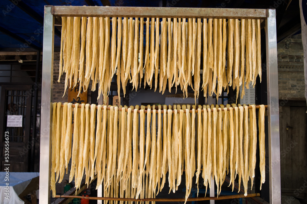 Dried yuba sticks hanging on shelf,beancurd stick made. Dried yuba sticks hanging on shelf,beancurd stick made.