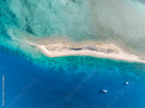 High angle aerial drone view of Langford Island's sandspit or sandbar, a small islet near Hayman Island in the Whitsunday Islands group near the Great Barrier Reef in Queensland, Australia. photo