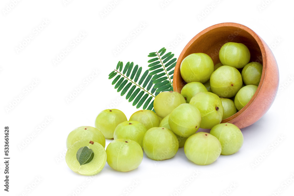 Indian gooseberry fruit or Amla (phyllanthus emblica) in wooden bowl with green leaf isolated on white background. Indian gooseberry fruit or Amla (phyllanthus emblica) in wooden bowl with green leaf isolated on white background.