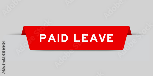 Red color inserted label with word paid leave on gray background photo