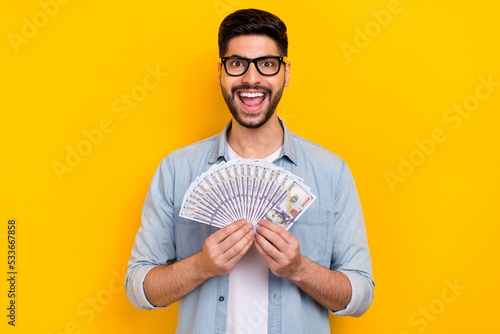Canvastavla Photo of happy young guy finally got salary holding money crazy isolated on yell