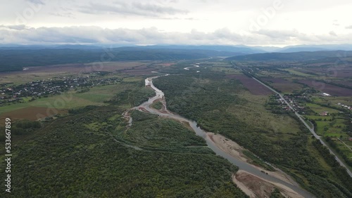 Aerial panoramic view on the wide Stryi river among woodlands photo