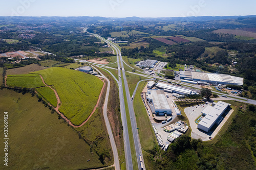 Aerial view of the Dom Pedro Highway at the height of the city of Itatiba. Industries, cars on the highway and vegetation on the side of the road. photo