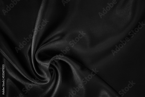 Black fabric cloth texture for background and design art work, beautiful crumpled pattern of silk or linen.