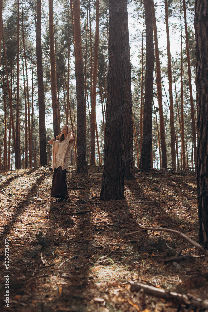 Caucasian Yogi girl in autumn sunset forest relaxes, catches zen Caucasian Yogi girl in autumn sunset forest relaxes, catches zen