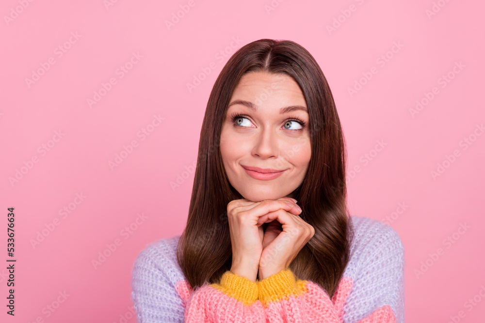 Photo of charming positive lady hands under chin look interested empty space isolated on pink color background Photo of charming positive lady hands under chin look interested empty space isolated on pink color background